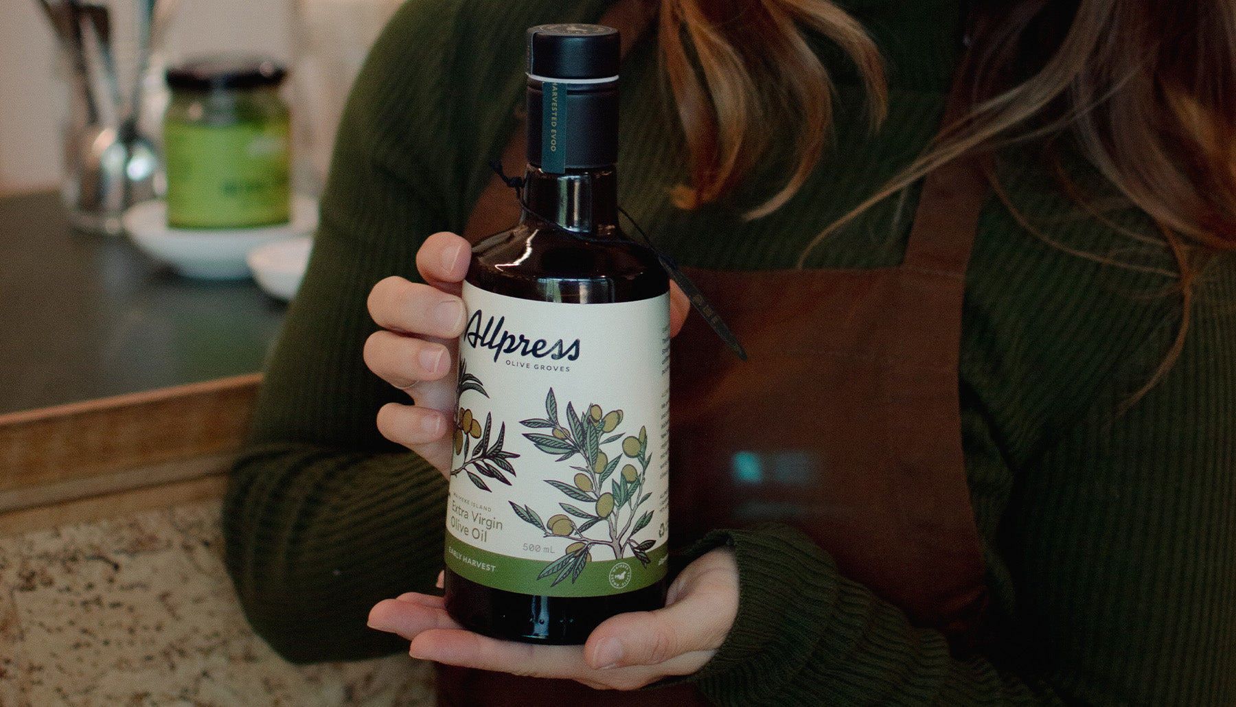 A person holding a bottle of Late Harvest Unfiltered 