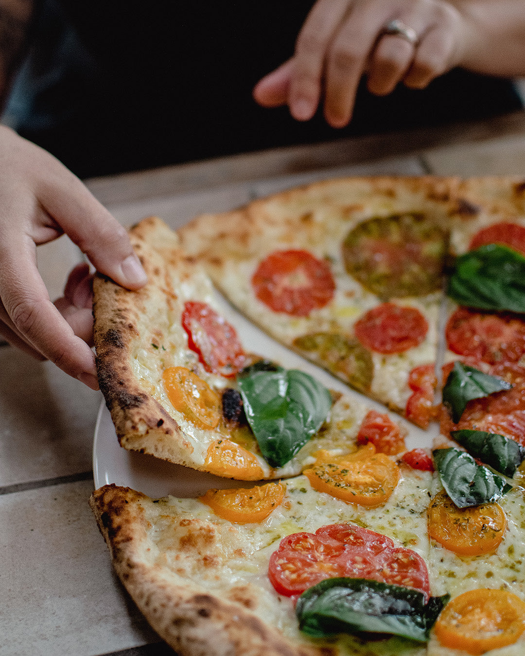 Heirloom tomato pizza with basil leaves from Bistro Allpress