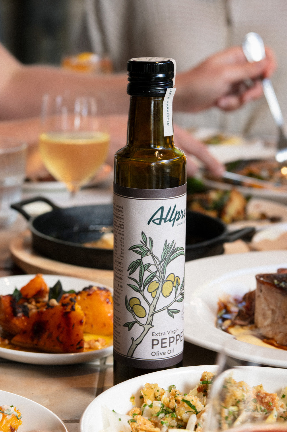 Bistro Allpress table setting with seasonal dishes and Allpress Olive Groves EVOO