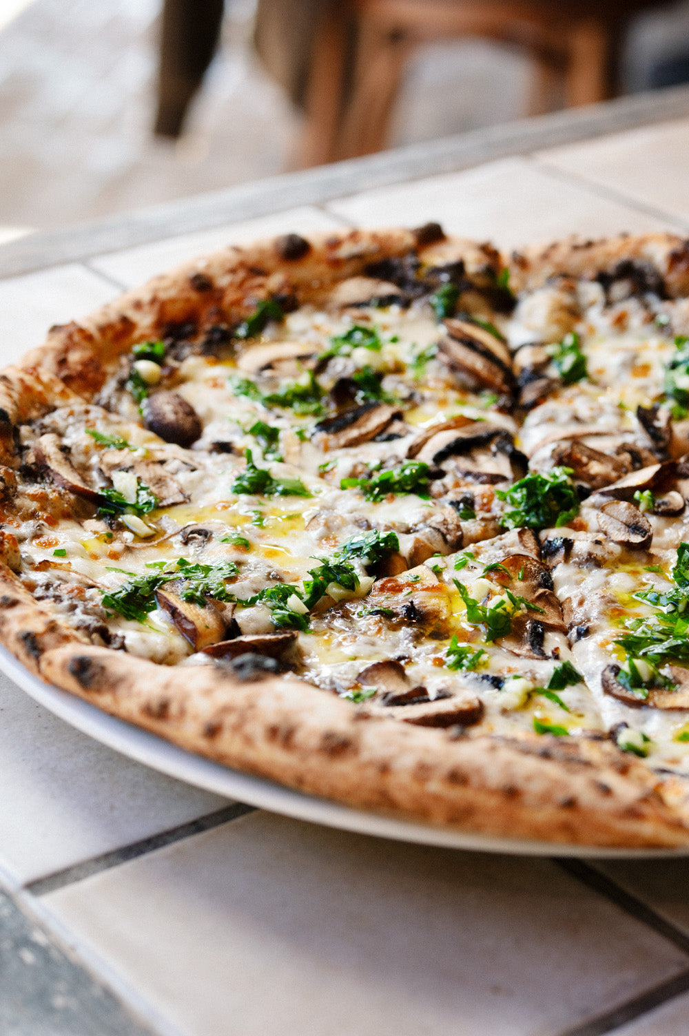 Freshly baked fungi pizza shared at Bistro Allpress restaurant on Waiheke Island