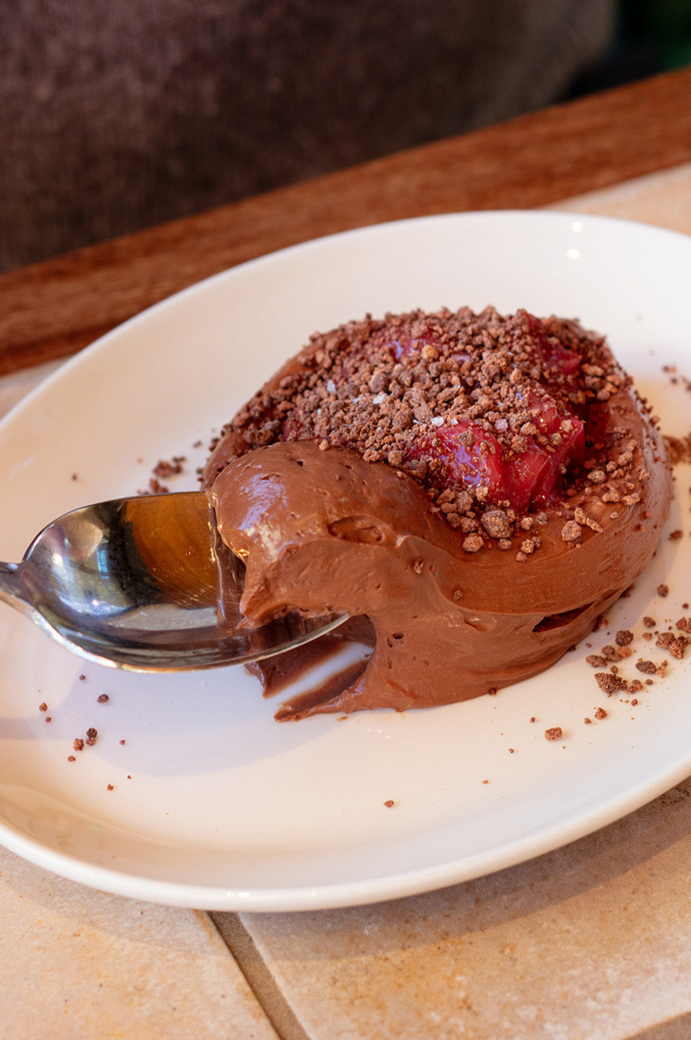 A close-up shot of a chocolate mousse dessert with rhubarb 