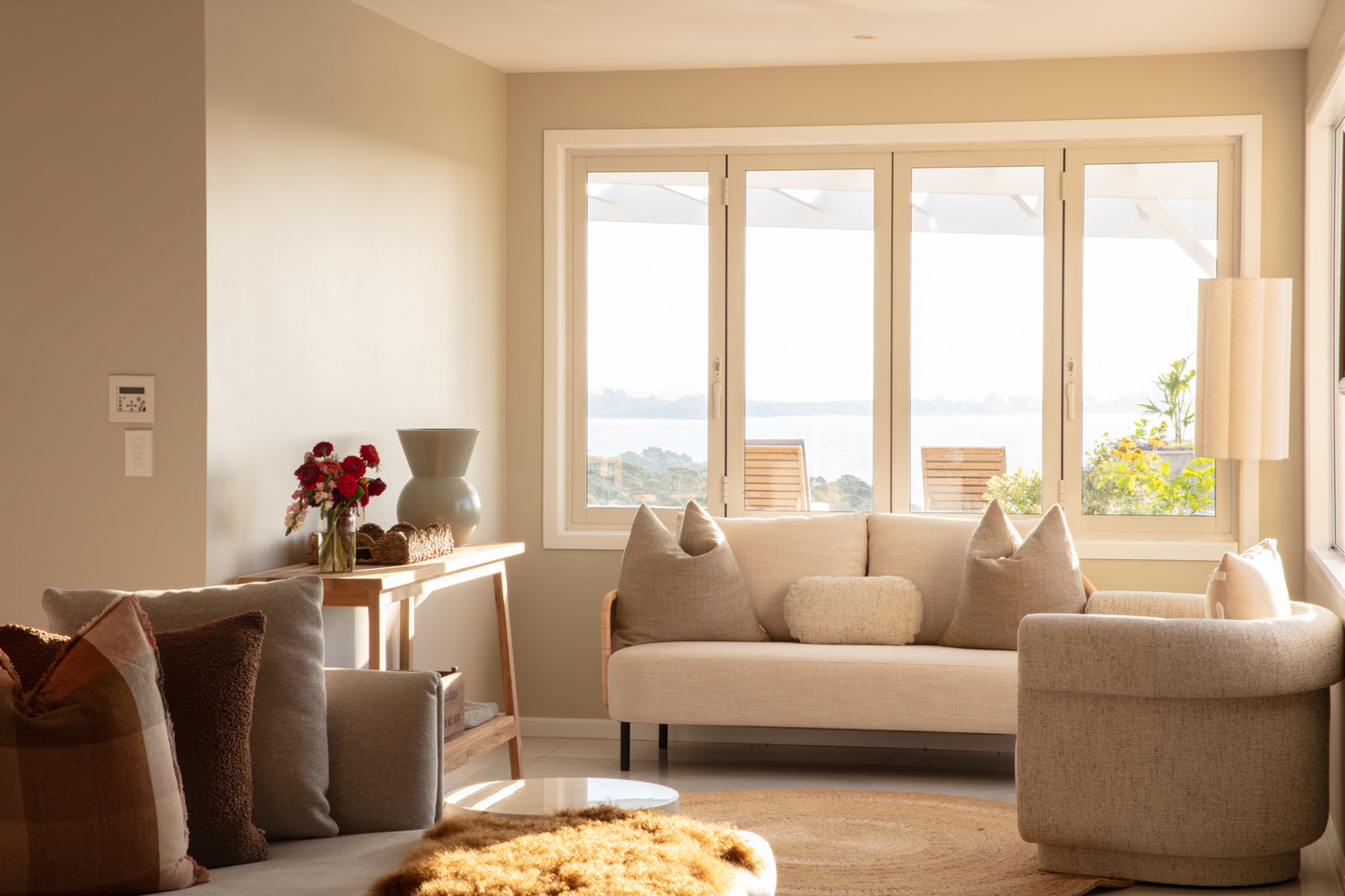 Modern living room with large windows overlooking the Hauraki Gulf
