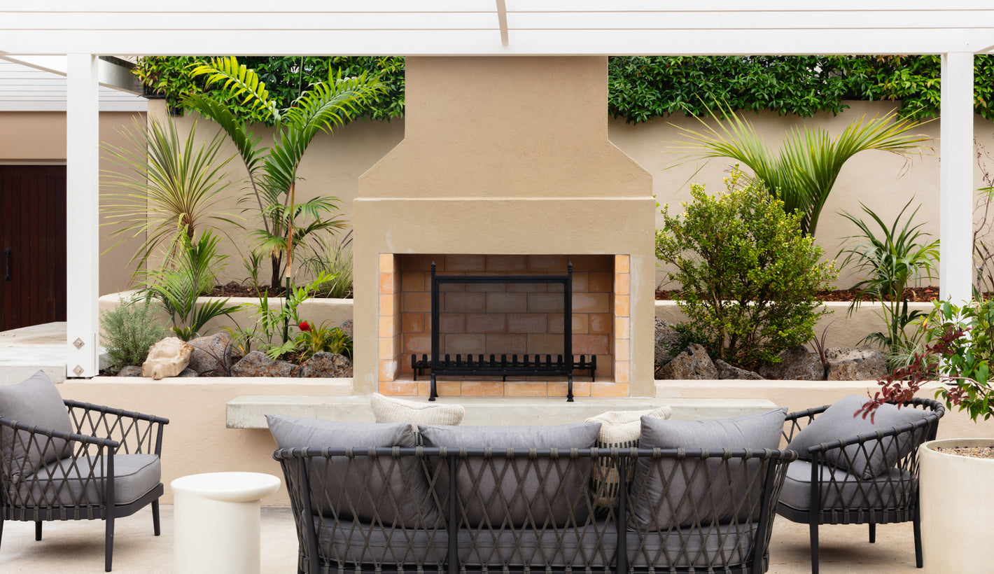 the Estate's outdoor patio with fireplace, chairs, and plants