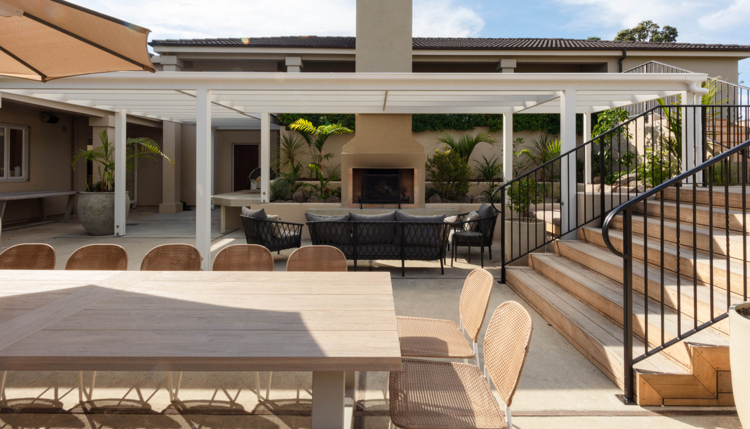 Outdoor patio with pool and lounge furniture at The Estate, Allpress Olive Groves
